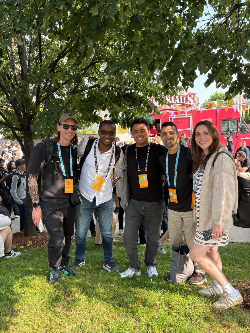 The team under a tree at a summer conference